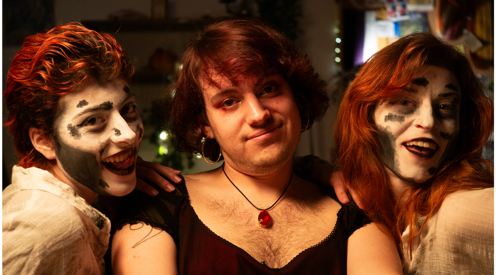 Girl looking at camera with two other people dressed as ghouls beside her on a film set