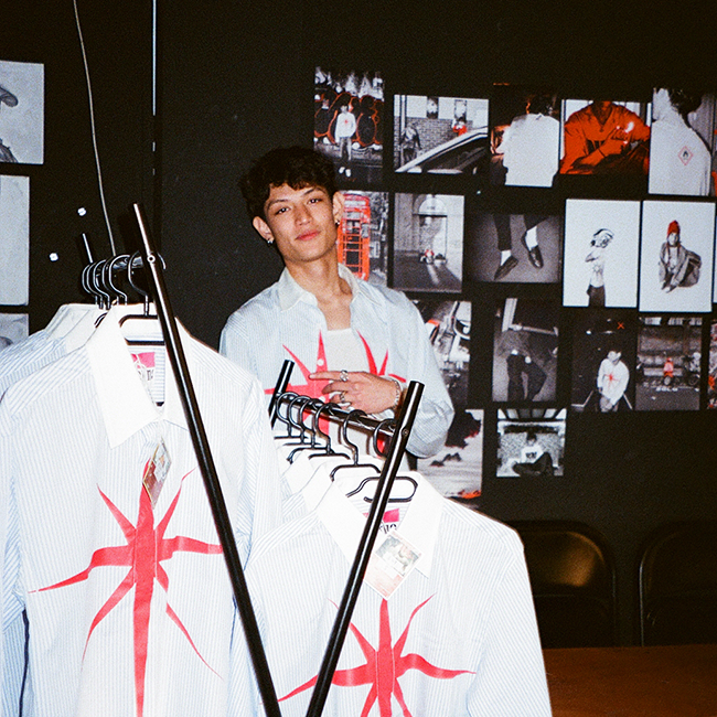 photo of Felipe selling own shirts from personal brand nFerno at Oneplatz's runway market in Bristol, Jan '25